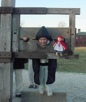Oh,no!  What could this young child and her doll have done to be put in the stocks?  note: the matching hoods!
