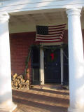 Well, this door is decorated for the holidays, and there is firewood outside.