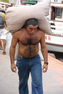 Man carrying 2 heavy bags of rice