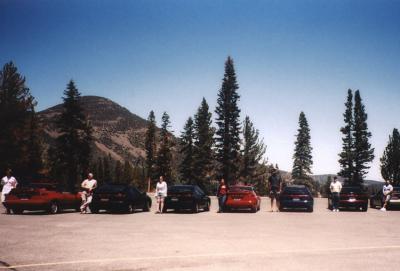 people and cars, mountain in background