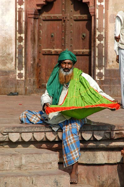 Colorful beggar on the steps of the Gate of Victory