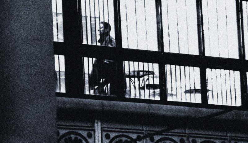 Man through bars