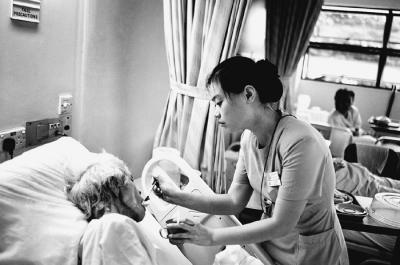 Nurse Feeding Elderly Patient