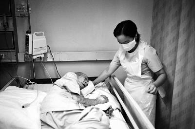 Nurse Turning Elderly Patient