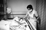 Nurse Turning Elderly Patient