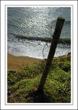 Fence post and sea, Hive beach, West Dorset