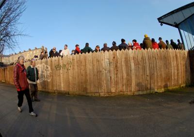 Rugby crowd along fence