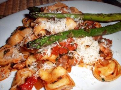 balsamic chicken with tortellini, braised asparagus and Parmesan cheese