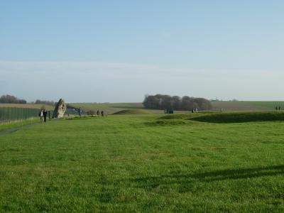 The Heel Stone to the left and a barrow to the right.