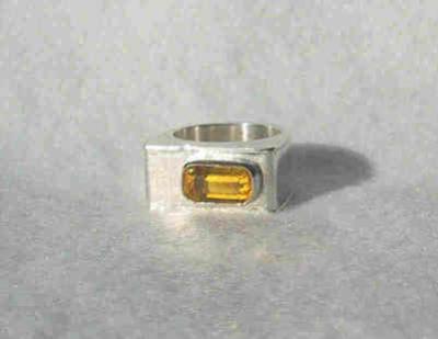 This ring is a 'hollow form' ring, and is not as heavy as it could be if it were solid.  The stone is a hand-faceted yellow quartz rectangle about 10 x 6 mm.
