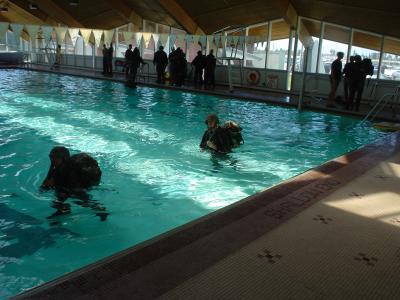 Swim qual. wearing cammies, boots, flak, kevlar, pack and rifle.