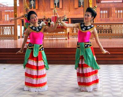 Two dancers in striped skirts