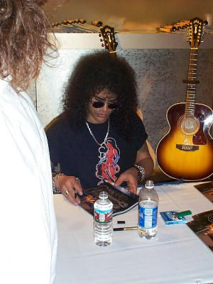 Slash signing autographs in the Guild booth