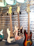 A master built relic P Bass, a strat carved by George Amicay and a J Bass