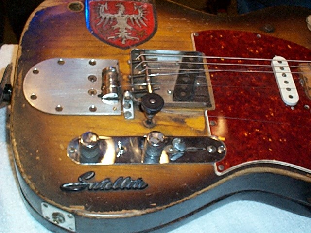 One bender is activated by applying pressure to the strap button, the other by pushing that knob.