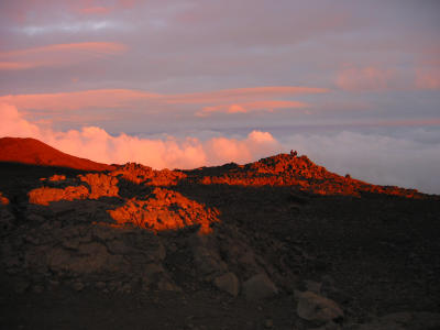 Absolutely surreal view on top of Mauna Kea between cloud layers at 12,000 ft. while the sun sets. This is exactly how it looked