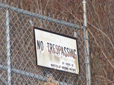 Unilingual No Trespassing sign at former base