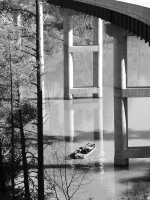 Fisherman under Crystal Falls bridge