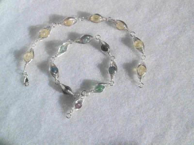 These bracelets feature wire-wrapped semi-precious stone beads.  SOLD