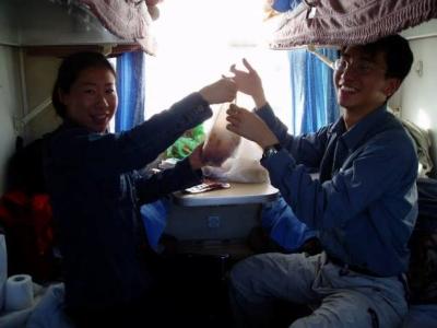 Mixing our noodles with its sauce in a plastic bag on a train.