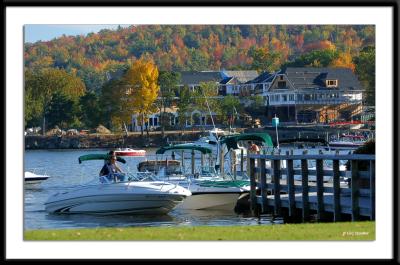 Boats arriving at docks in Meredith, NH in Lake Winnapesaukee.
