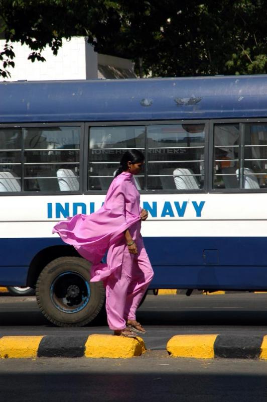Woman in a flowing Shalwar Kameez (Punjabi Suit) and an Indian Navy bus