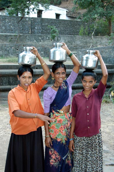 Locals posing with water jugs (mutkas) for money