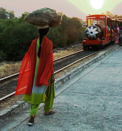 Woman carrying a load and the tourist train