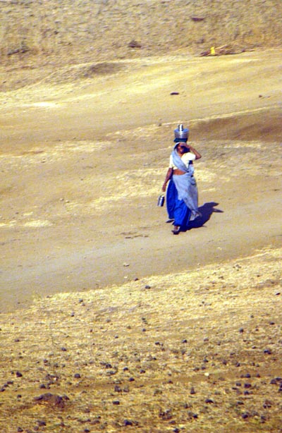 Woman carrying a water container