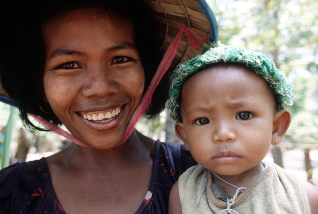   On a circular tour of the Siem Reap area, I stopped at a village where palm sugar is produced. Many friendly faces there, including these two.