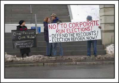 Early arrivers line up with their signs...