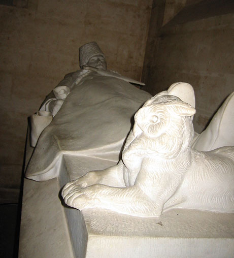 One of several effigies with animals at their feet