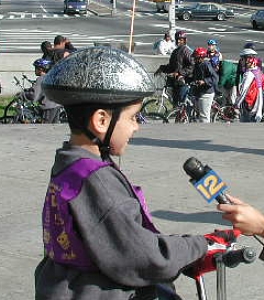 A younger rider does a Stand Up on the courthouse steps.