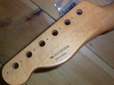 The neck came finished, with a serial number and tuner screw holes drilled