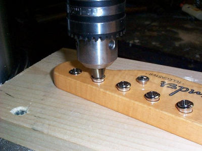 The drill press comes in handy pressing the tuner bushings in