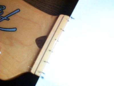 Using another guitar as a template I've marked the slot positions on the nut