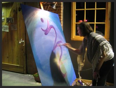 Sandra paints during Paul Cebar concert.jpg