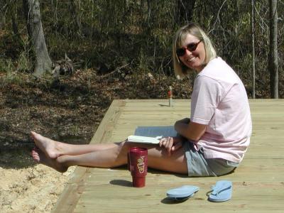 Heather enjoys an iced tea and a good book on the rear deck