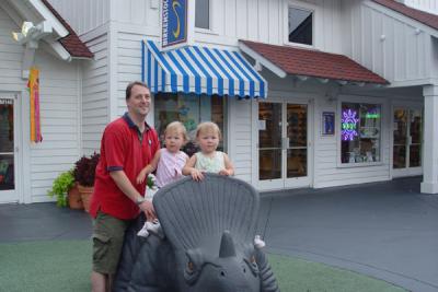 Daddy, Reagan (in the pink) and Rory riding the Dinosaur at Broadway on the Beach