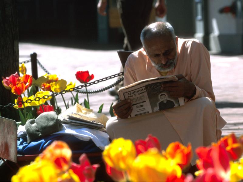 Man reading newspaper in Boulder, Colorado