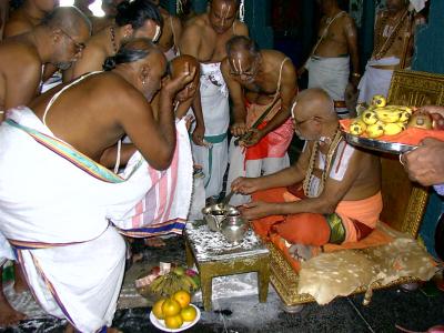 Swamy offering ShreepAda theertham to devotees-2