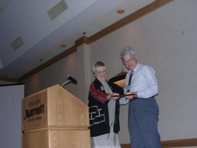 Dee Daneri presenting an award to Bob Weissman, ARS webmaster