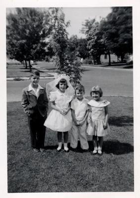 Mary's First Communion with John, Mike and Mary Claire.  Maple tree in background, 1956 (441)