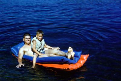 Jim with Dan floating in the lake, 1960 (636)