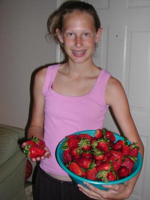 Sarah displays our strawberry pickings from a local patch