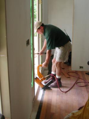 Coel finishes the last couple rows of flooring  04/26/2002