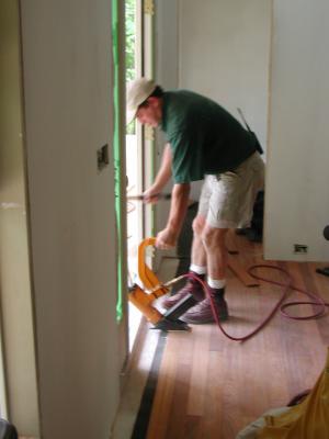 Coel finishes the last couple rows of flooring 04/26/2002