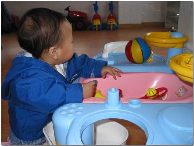 Anna playing with toys in playroom
