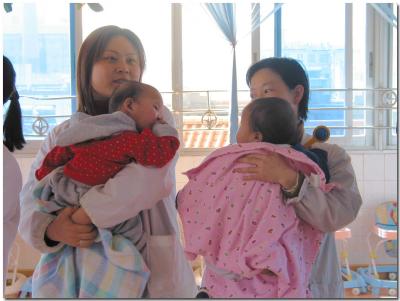 Staff holding babies