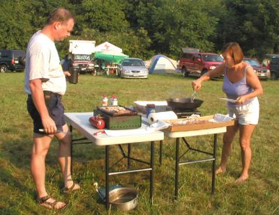 Bob Cooke and Alison Skeel fry some bacon for the MASHOUT Sunday community breakfast